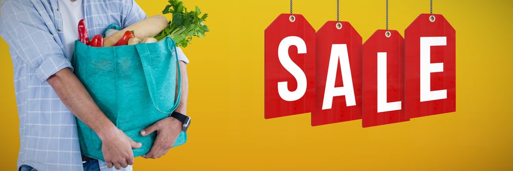 Man carrying vegetables in shopping bag against white background against abstract mustard background