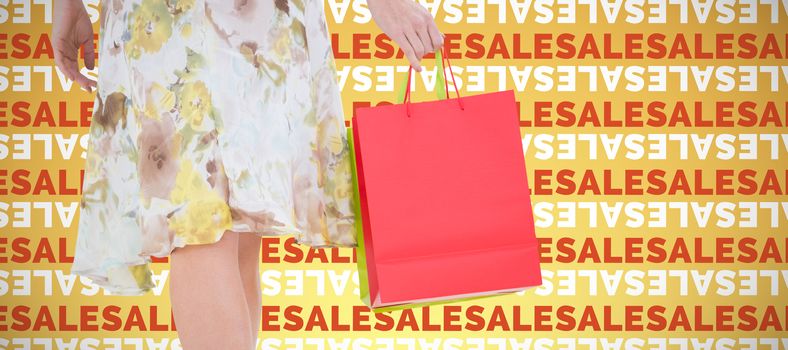 Elegant woman with shopping bags against abstract yellow background