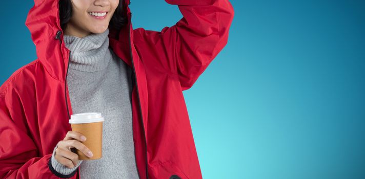 Woman in red jacket having coffee against white background against abstract blue background