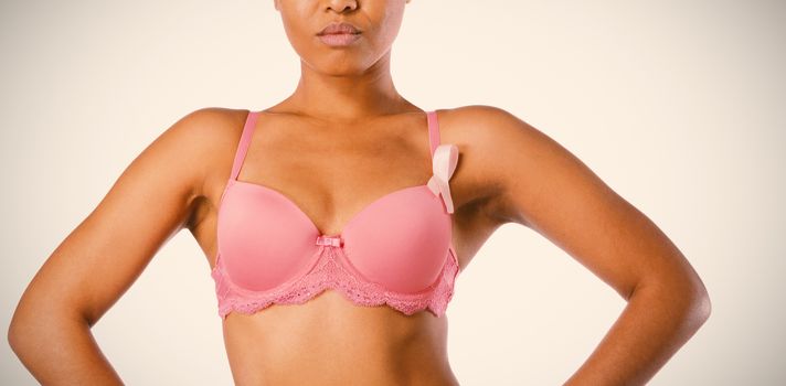 Standing woman for breast cancer awareness with ribbon on white background