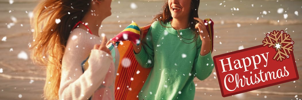 Greetings board against  two female friends having fun in beach