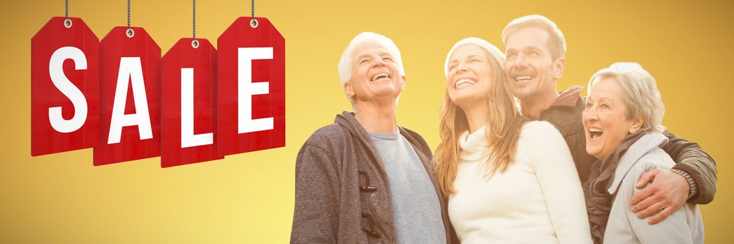 senior family laughing against abstract yellow background