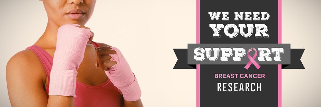 Breast cancer awareness message against mid section of woman with gloves for breast cancer awareness