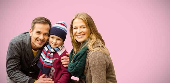  Portrait of family smiling together against pink background
