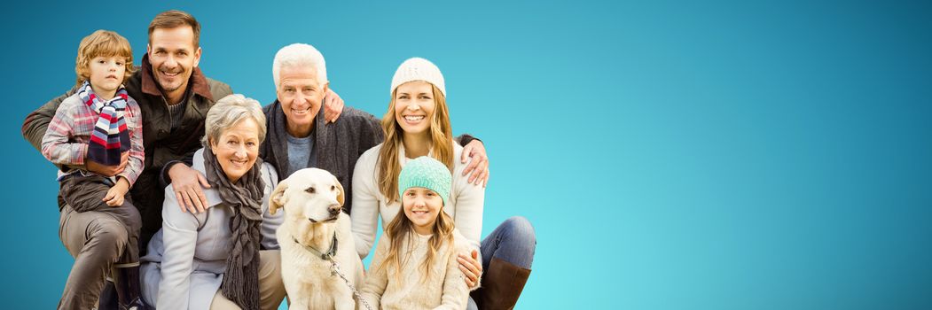 Portrait of family with dog in park against abstract blue background