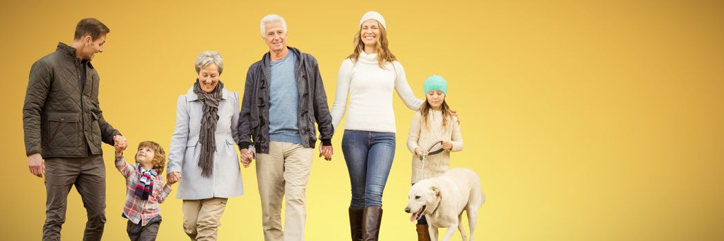 Happy family walking with their dog against abstract yellow background