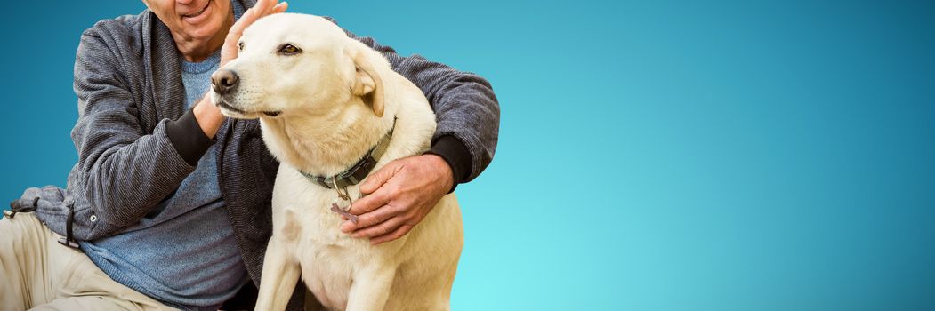 Smiling old man sitting stroking his pet dog against abstract blue background
