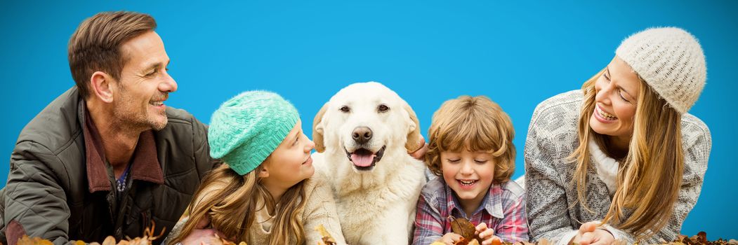Young family with a dog against blue background