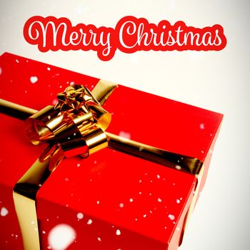 White and red greeting card against christmas gift with golden bow