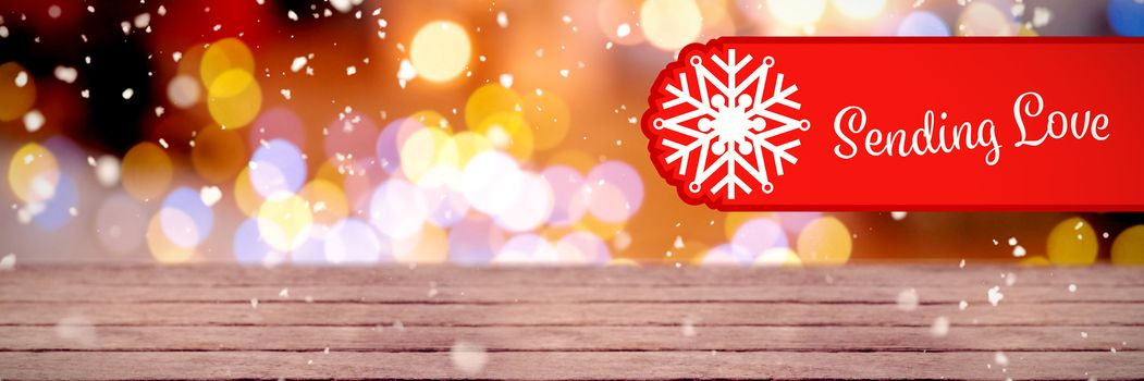 Banner sending love against defocused of christmas tree lights and fireplace