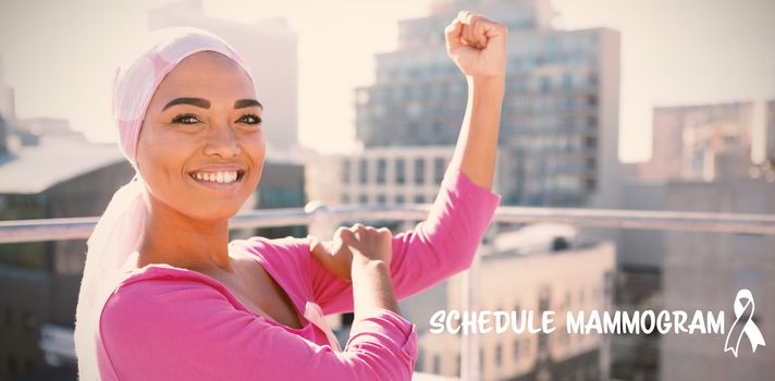 Schedule mammogram text with breast cancer awareness ribbon against strong woman in city with breast cancer awareness
