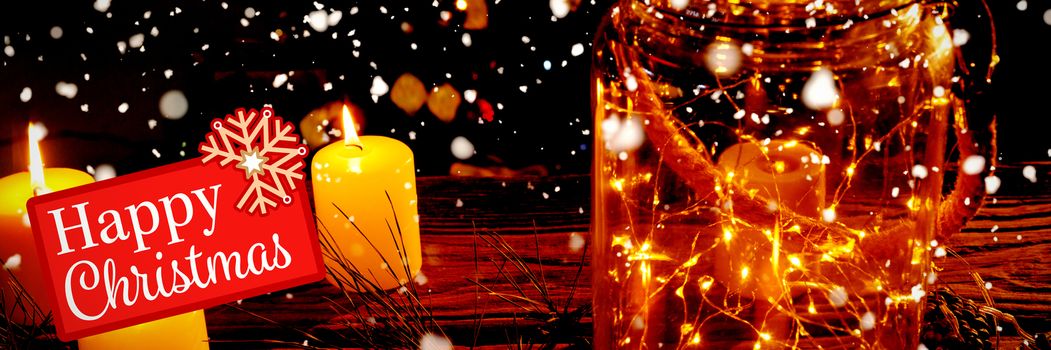 Greetings board against small electric garland in a glass jar with candles