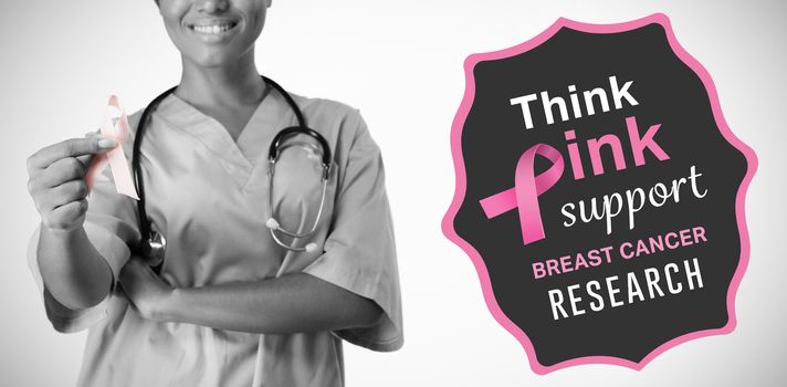 Breast cancer awareness message against smiling nurse hold breast cancer awareness pink ribbon