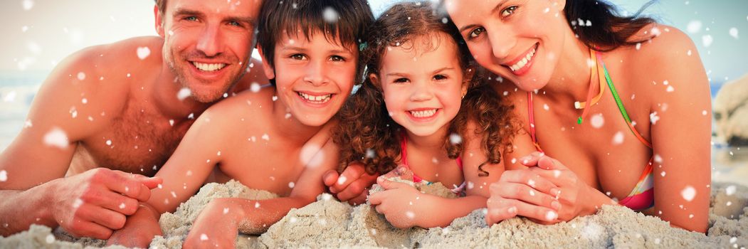 Family at the beach against snow falling