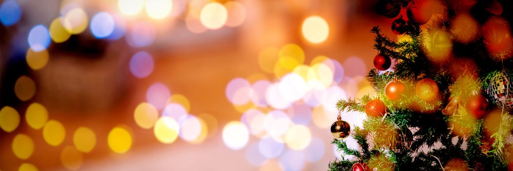 Christmas yellow circle lights against christmas pine tree with gifts