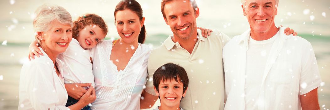 Beautiful family at the beach against snow falling