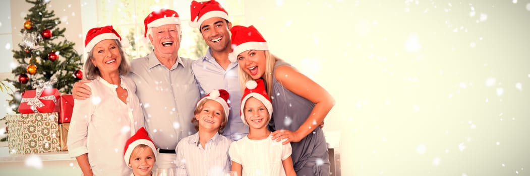 Family posing for photo against snow falling