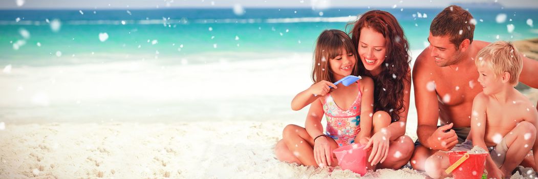 Portrait of a family at the beach against snow falling