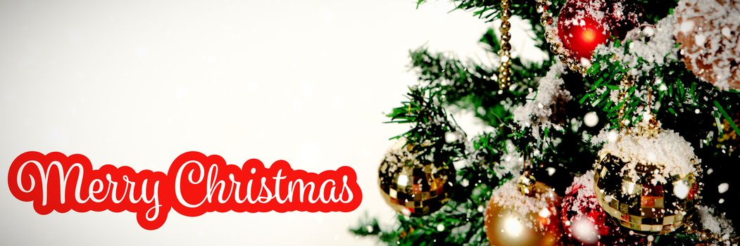 White and red greeting card against christmas ornaments hanging in tree