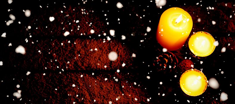 Snow falling against copy space with christmas candles in the night
