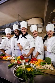 Group of chefs preparing food in kitchen at hotel