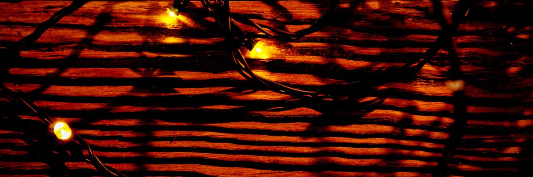 Christmas electric garland on a wooden background