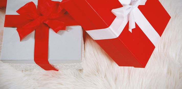 Christmas gifts on a white fur carpet