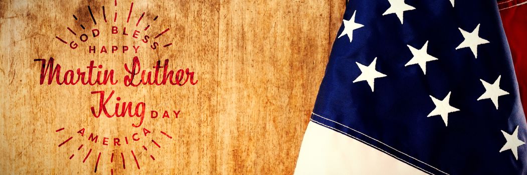 happy Martin Luther King day, god bless america against american flag on a wooden table