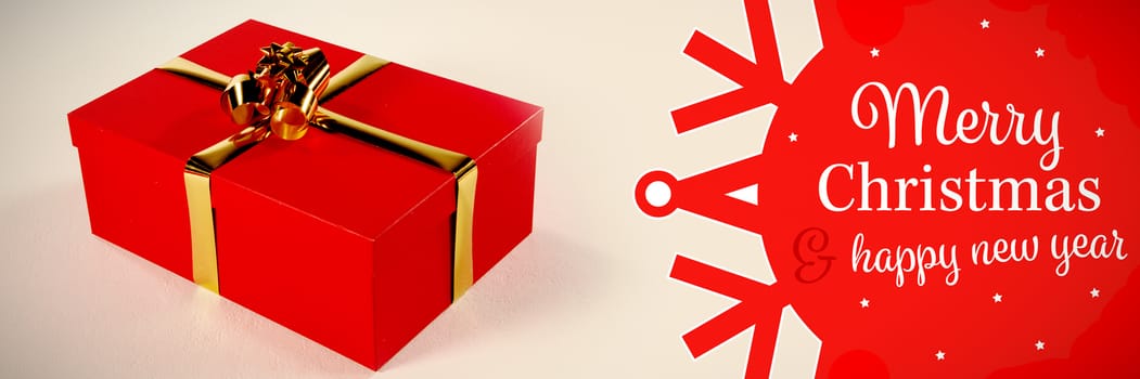 White and red greetings card against red christmas gift on white background