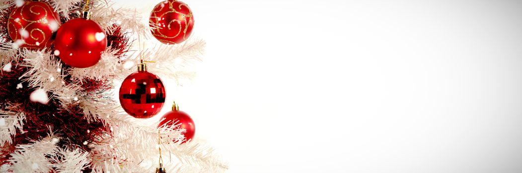Snow falling against copy space with christmas tree