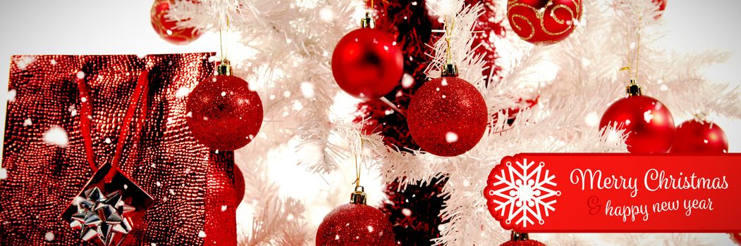 Banner Merry Christmas against close-up of christmas tree and gifts