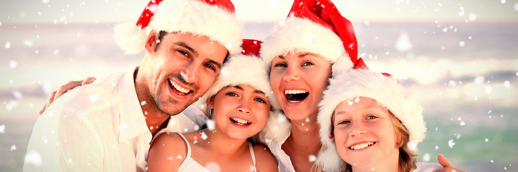 Family during Christmas day at the beach against snow falling