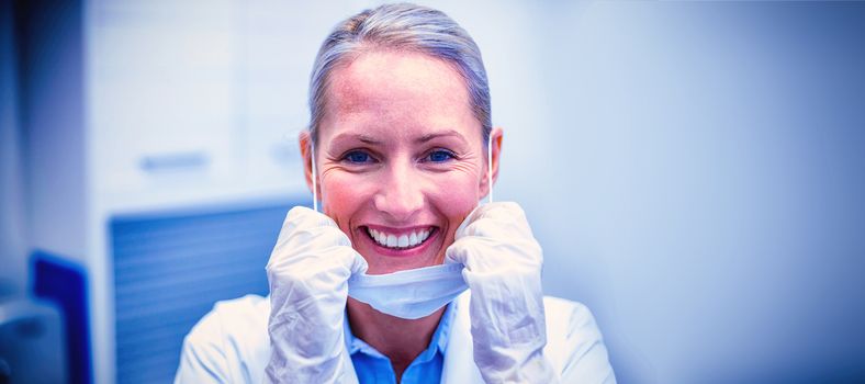 Portrait of female dentist smiling in dental clinic