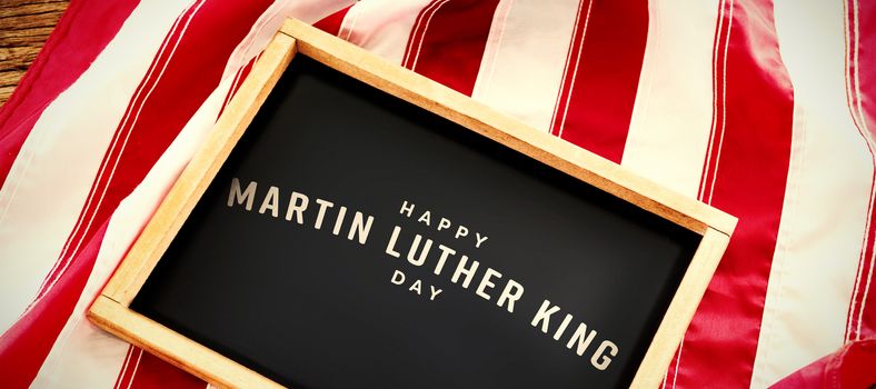 happy Martin Luther King day against american flag with slate on wooden table