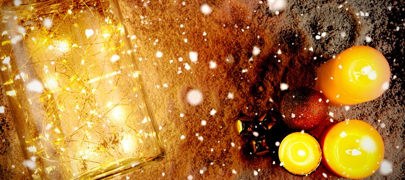 Snow falling against candles and smooth christmas lights