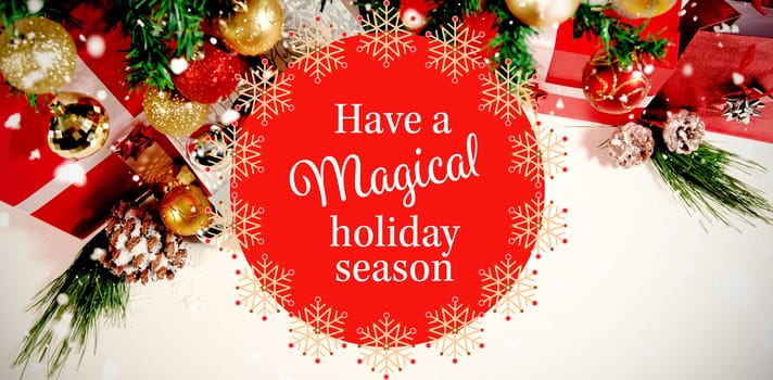 White and red greetings card against beautiful christmas decoration with copy space