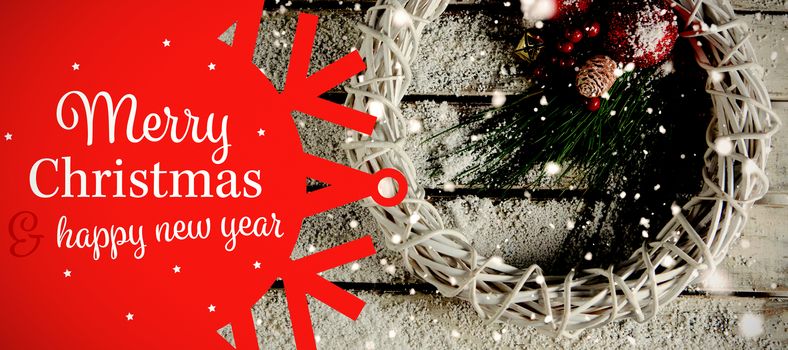 White and red greetings card against simple christmas crown in the snow