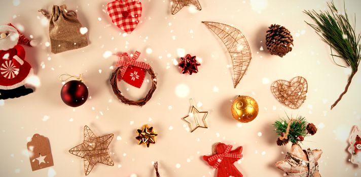 Snow falling against several christmas decorations