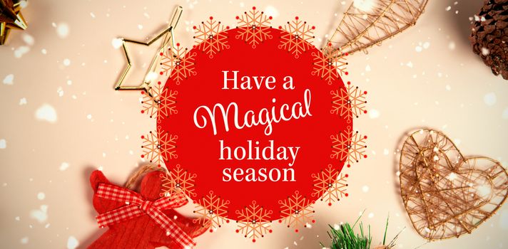 White and red greetings card against close-up on christmas decorations