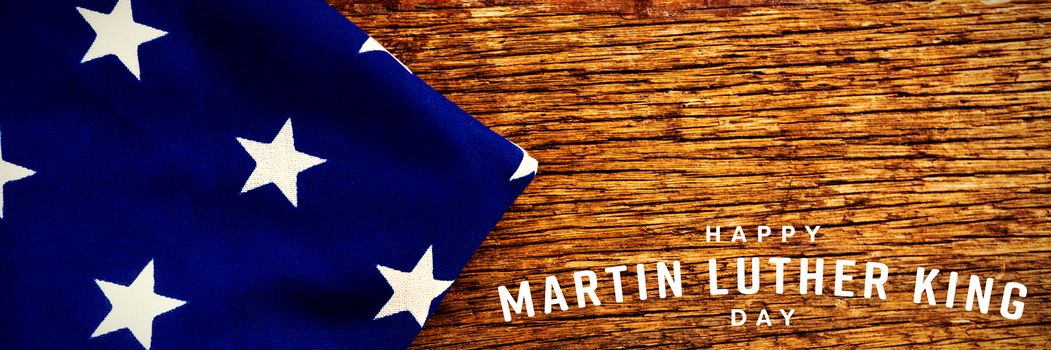 happy Martin Luther King day against american flag on a wooden table