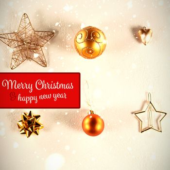 Banner Merry Christmas against yellow and golden christmas ornaments