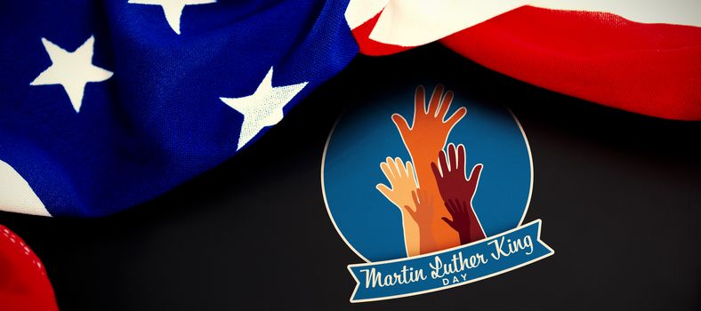 Martin Luther king day with hands against american flag on blank slate