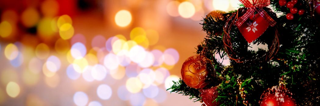 Christmas yellow circle lights against part of christmas tree against white background