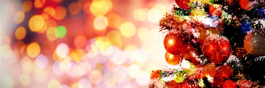 Christmas yellow circle lights against christmas decorations hanging in tree