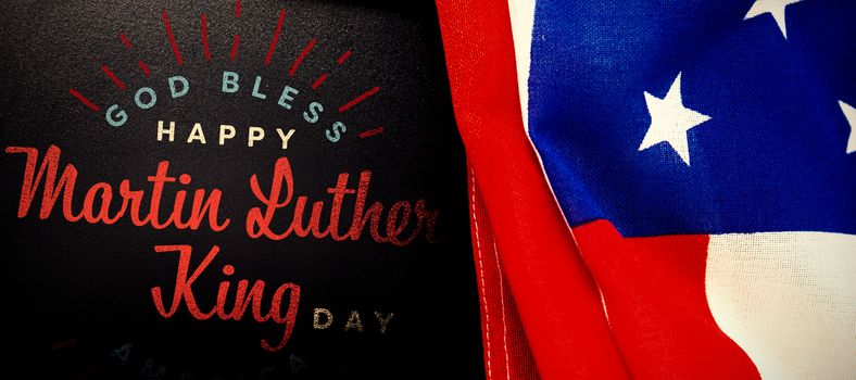 happy Martin Luther King day, god bless america against american flag and blank slate on wooden table