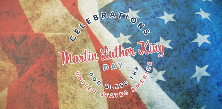 Martin Luther king day against close-up of crumbled american flag