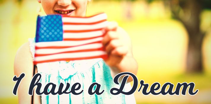 Portrait of girl showing American flag against i have a dream