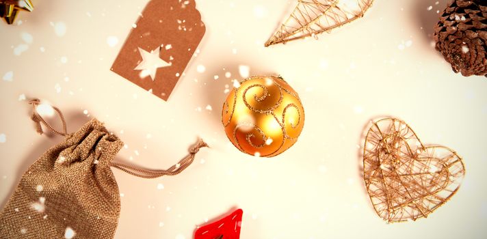 Snow falling against old christmas ornaments