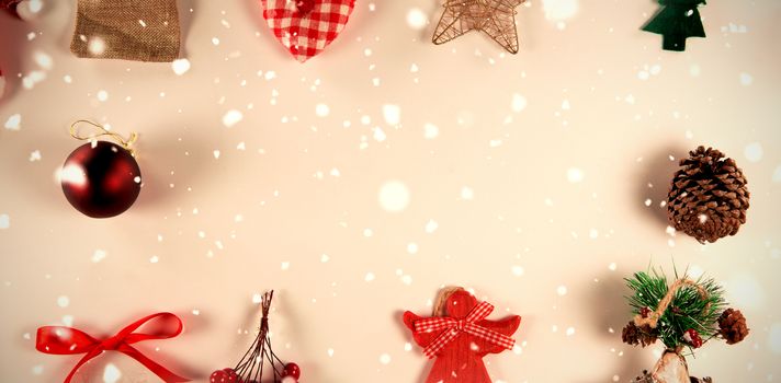 Snow falling against copy space with christmas ornaments around