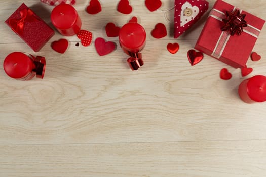 Overhead of gift boxes and heart shape decorations on wooden table